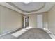 Bedroom with neutral carpet, tray ceiling and natural light from window, and entry to hallway at 1400 Scenic Brook Sw Trl, Conyers, GA 30094
