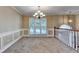 Elegant dining room boasting wainscoting, a chandelier, and large windows with a scenic view at 1400 Scenic Brook Sw Trl, Conyers, GA 30094