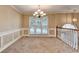 Bright dining room with large windows and a stylish chandelier fixture at 1400 Scenic Brook Sw Trl, Conyers, GA 30094