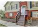 Inviting front entrance featuring a white door, brick accents, and wooden steps leading to the home at 1400 Scenic Brook Sw Trl, Conyers, GA 30094