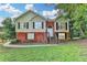 Charming two-story home with brick and siding, complemented by a well-manicured lawn and mature trees at 1400 Scenic Brook Sw Trl, Conyers, GA 30094