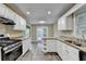 Bright kitchen featuring granite countertops, stainless steel appliances, and ample cabinet space at 1400 Scenic Brook Sw Trl, Conyers, GA 30094