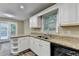 Bright kitchen featuring granite countertops, stainless steel appliances, and ample cabinet space at 1400 Scenic Brook Sw Trl, Conyers, GA 30094