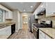 Well-lit kitchen featuring granite countertops, stainless steel appliances, and ample cabinet space at 1400 Scenic Brook Sw Trl, Conyers, GA 30094