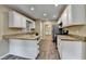 Well-lit kitchen featuring white cabinets, granite counters, stainless appliances and wood-look flooring at 1400 Scenic Brook Sw Trl, Conyers, GA 30094