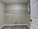 Functional laundry room with wire shelving and wood-look flooring at 1400 Scenic Brook Sw Trl, Conyers, GA 30094