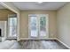 Spacious living room with wooden flooring, double doors to the deck, and ample natural light at 1400 Scenic Brook Sw Trl, Conyers, GA 30094