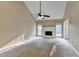 Spacious living room featuring a fireplace, ceiling fan, and windows providing ample natural light at 1400 Scenic Brook Sw Trl, Conyers, GA 30094