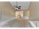 Bright living room with a vaulted ceiling, ceiling fan, and windows bringing in plenty of natural light at 1400 Scenic Brook Sw Trl, Conyers, GA 30094