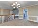 Open-concept area showcasing neutral paint, staircase, and an entry to the adjacent kitchen at 1400 Scenic Brook Sw Trl, Conyers, GA 30094