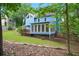 Inviting backyard featuring a well-maintained lawn, a wooden deck, and a charming blue house at 1911 Woodmont Ct, Marietta, GA 30062