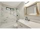 Bathroom featuring marble tiling in shower, stylish sink and vanity with contemporary mirror at 1911 Woodmont Ct, Marietta, GA 30062
