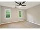 Cozy bedroom with neutral walls, ceiling fan and plush carpeting plus two windows bringing in natural light at 1911 Woodmont Ct, Marietta, GA 30062