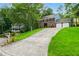 Classic two-story home with a long driveway and lush green lawn at 1911 Woodmont Ct, Marietta, GA 30062