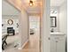 Bright hallway with light wood floors, a modern powder room, and access to the living area at 1911 Woodmont Ct, Marietta, GA 30062