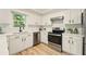 Well-lit kitchen with white cabinets and stainless steel appliances at 1911 Woodmont Ct, Marietta, GA 30062