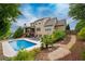 Expansive backyard features a private pool, sundeck, covered patio, and lush landscaping for ultimate outdoor living at 200 Glenview Ct, Woodstock, GA 30188
