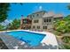 A large backyard with a pool, patio area, and lush landscaping, perfect for outdoor living and entertaining at 200 Glenview Ct, Woodstock, GA 30188