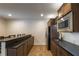 Finished basement bar area featuring a refrigerator, microwave, sink, and countertop seating at 200 Glenview Ct, Woodstock, GA 30188
