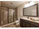 Luxurious bathroom with a glass-enclosed shower, dark wood vanity, and elegant tile flooring at 200 Glenview Ct, Woodstock, GA 30188