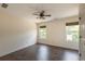 Well-lit bedroom with hardwood floors, ceiling fan and two large windows at 200 Glenview Ct, Woodstock, GA 30188