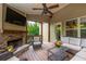 Inviting covered deck featuring a stone fireplace, cozy seating, and serene backyard views at 200 Glenview Ct, Woodstock, GA 30188
