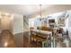 Open dining room boasts hardwood floors, chandelier, and flows into the living room at 200 Glenview Ct, Woodstock, GA 30188