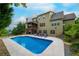 Back exterior view of home featuring a pool and screened porch with outdoor staircase at 200 Glenview Ct, Woodstock, GA 30188