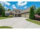 Charming home featuring lush landscaping, a wide driveway, and a welcoming front porch at 200 Glenview Ct, Woodstock, GA 30188