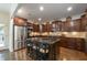 Gourmet kitchen with granite counters, stainless steel appliances, and a large center island at 200 Glenview Ct, Woodstock, GA 30188