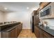 Finished basement features a bar and kitchenette with stainless steel appliances and dark wood cabinetry at 200 Glenview Ct, Woodstock, GA 30188