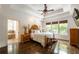 Main bedroom with tray ceiling, hardwood floors, and ample natural light from large windows at 200 Glenview Ct, Woodstock, GA 30188