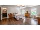 Spacious main bedroom featuring hardwood floors, two windows, and an ensuite bathroom at 200 Glenview Ct, Woodstock, GA 30188