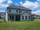 Spacious backyard showing covered patio with seating and a lush green lawn at 2949 Longbush, Duluth, GA 30097