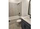 Bathroom showing a shower-over-tub combo, blue vanity, and grey tile flooring at 2949 Longbush, Duluth, GA 30097