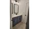 Elegant bathroom featuring double sinks, modern fixtures, and stylish navy blue vanity at 2949 Longbush, Duluth, GA 30097