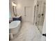 Bathroom features a soaking tub, dark blue vanity, and glass enclosed shower with marble tile at 2949 Longbush, Duluth, GA 30097