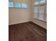 This bedroom features wood floors and large windows allowing for ample natural light at 2949 Longbush, Duluth, GA 30097