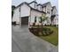 New two-story home with a light brick facade, dark roof, well-manicured lawn and a two-car garage at 2949 Longbush, Duluth, GA 30097