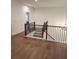 Second story hallway features dark wood floors and railing leading to the staircase at 2949 Longbush, Duluth, GA 30097