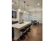 Bright, open-concept kitchen featuring an island with seating and a view to a dining area at 2949 Longbush, Duluth, GA 30097