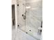 Shower featuring marble style tiles and a glass door at 2949 Longbush, Duluth, GA 30097