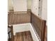 Staircase with hardwood treads, black iron railings, and a view of the upper level at 2949 Longbush, Duluth, GA 30097