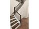 Staircase features dark wood and metal banisters, and dark wood floors at 2949 Longbush, Duluth, GA 30097