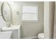 Cozy bathroom featuring white vanity, granite countertop, brushed nickel faucet and window with blinds at 3333 Old Salem Se Rd, Conyers, GA 30013