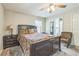 Comfortable bedroom with dark wood furnishings, neutral decor, and a ceiling fan, creating a serene retreat at 3333 Old Salem Se Rd, Conyers, GA 30013