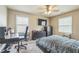Functional bedroom featuring a desk, ceiling fan, and neutral decor creating a comfortable and functional space for relaxation and work at 3333 Old Salem Se Rd, Conyers, GA 30013