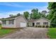 Single-story home with attached garage, concrete driveway and mature trees in the background at 3333 Old Salem Se Rd, Conyers, GA 30013