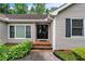 Close-up of front entry with black door, brick steps, and well-maintained landscaping at 3333 Old Salem Se Rd, Conyers, GA 30013