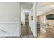 Hallway featuring wood floors, neutral paint and a view into the living room at 3333 Old Salem Se Rd, Conyers, GA 30013